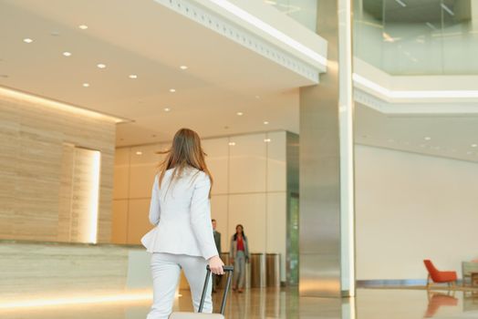 Business woman walking through an airport terminal for business travel. Business woman walking through an airport terminal for business travel.