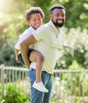 I just want to give him the best. Portrait of a father giving his son a piggyback ride outdoors.