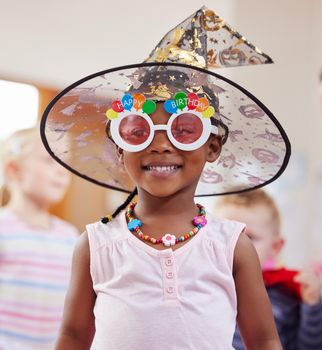 Let your imagination run wild. Shot of a little girl playing dress-up in class.