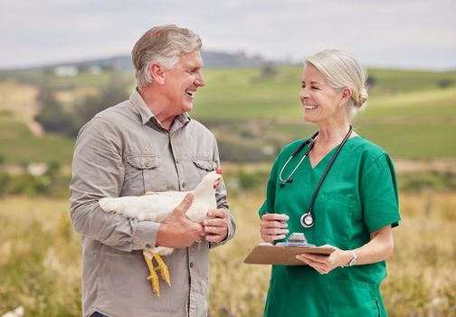 Providing advice about proper avian care and treatment. Shot of a man having a discussion with a veterinarian on a poultry farm.