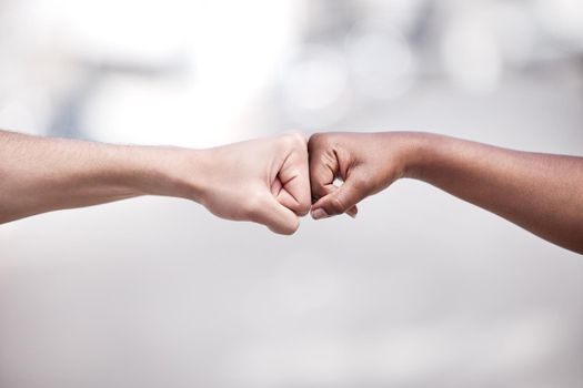 Different backgrounds wont separate us. Shot of two protestors fist bumping one another in solidarity.