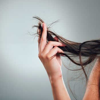 What else can I use for my damaged hair. Cropped shot of an unrecognizable woman holding up her damaged hair.
