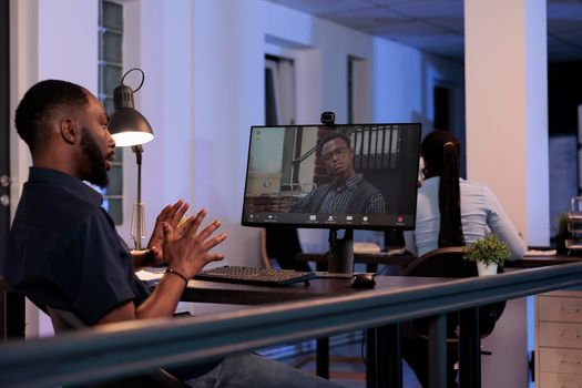 Project manager talking to office worker on online videocall