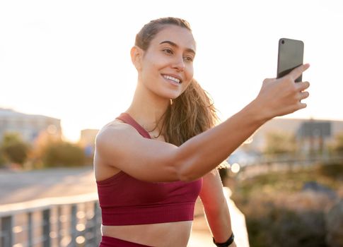 Mandatory workout selfie. Shot of a young woman taking a selfie while on a run outside.