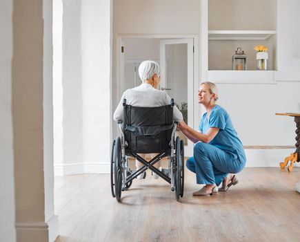 She truly inspires to help and care. Shot of a nurse caring for a senior woman in a wheelchair in a retirement home.