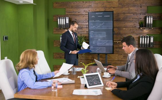 Businessman in suit checking his note on clipboard