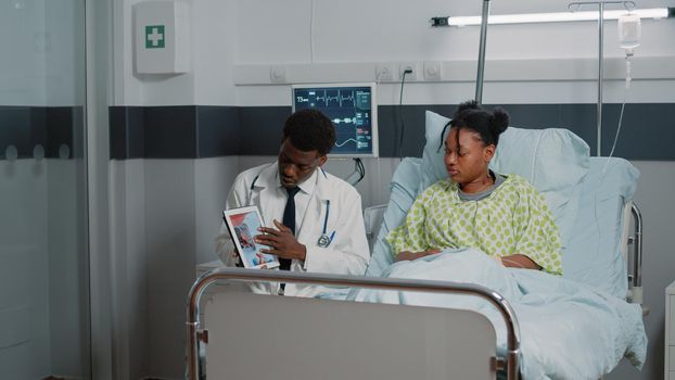 Man explaining cardiology diagnosis to patient with illness