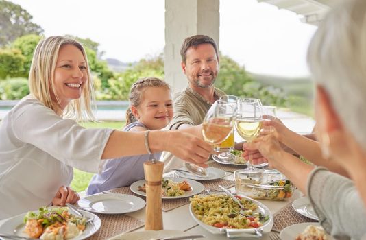 To health and wellness. Shot of a family toasting during a sunday lunch.