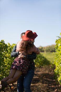Cheerful young couple having a romantic moment in a vinyard