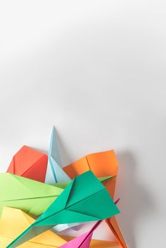 Give your creativity wings to fly. Studio shot of a pile of colourful origami planes.