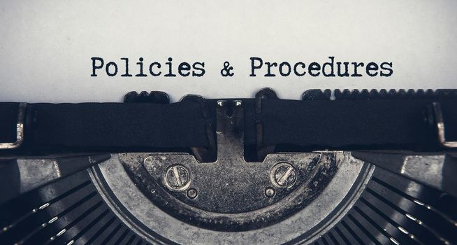 Policies and procedures text typed on an old vintage typewriter. Rules concept