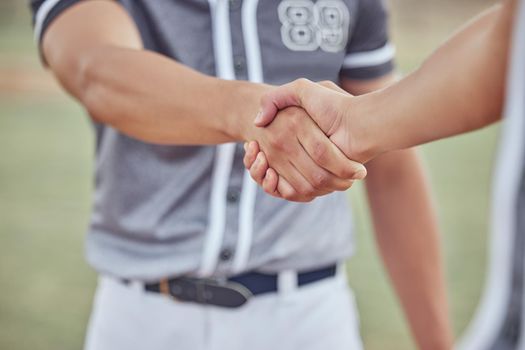 Closeup of two sportsmen shaking hands before a game. Hands pf baseball players congratulating each other after winning a match. Two unknown male competitors wishing each other goodluck on the field