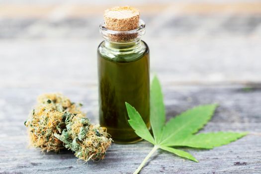 Bottle of Cannabis Oil with Bud