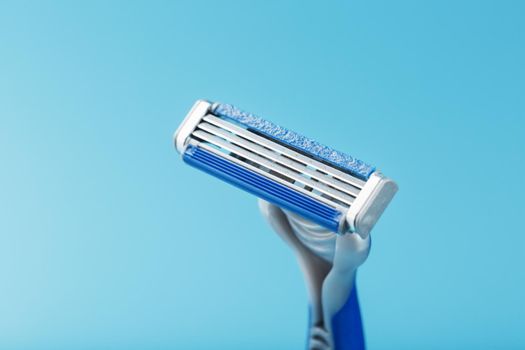 Shaving machine for the face on a blue background top view free space