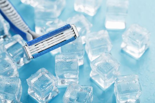 Refreshing shaving machine on the background of frosty ice cubes without irritation