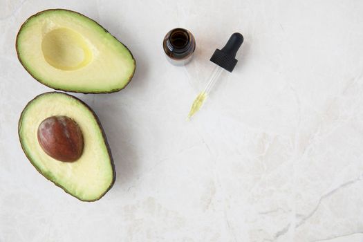 Avocados and Dropper of Oil