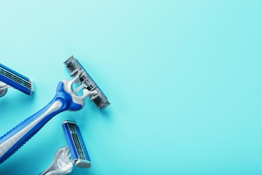 Blue shaving machines in a row on a blue background with ice cubes