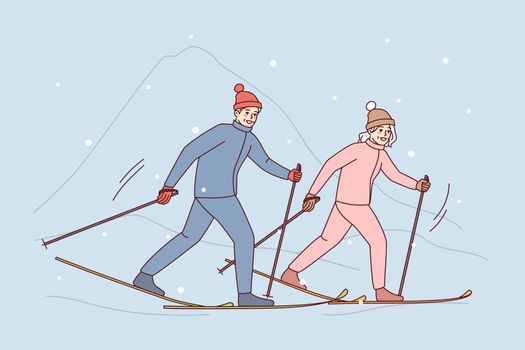 Couple enjoy skiing in mountains