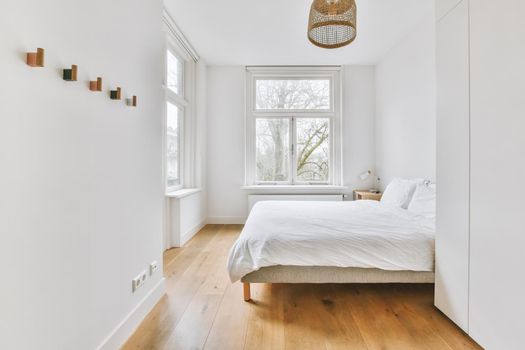 Light bedroom with wooden wardrobe
