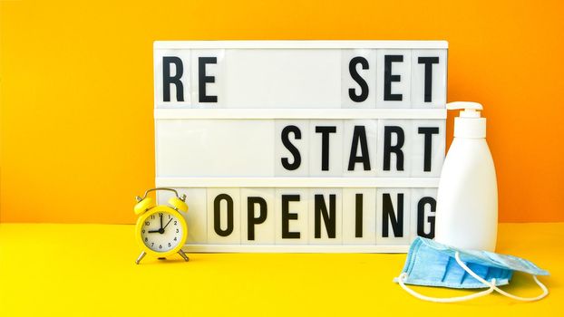 Words reset, restart and reopening text on the light box. New life, new business, new deals concept. Alarm clock. New normal