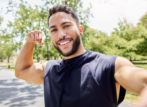Biceps dont grow on trees. Portrait of a sporty young man flexing his bicep and taking selfies while exercising outdoors.