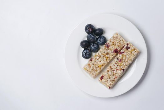 blackberry oat protein bars on white background