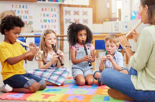 We love learning about musical instruments. Shot of children learning about musical instruments in class.