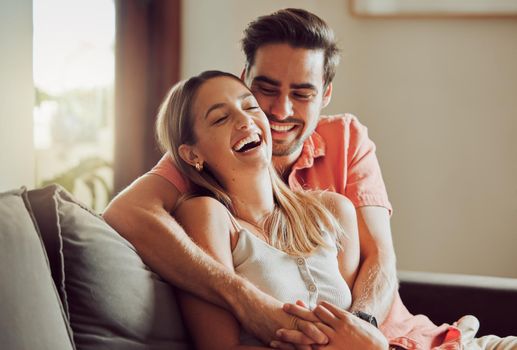 Laughter makes our bond stronger. Shot of a young couple spending time together at home.