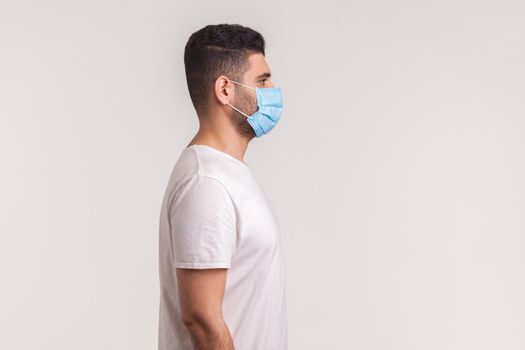 Side view of man wearing mask to prevent infection, respiratory illnesses such as flu, 2019-nCoV
