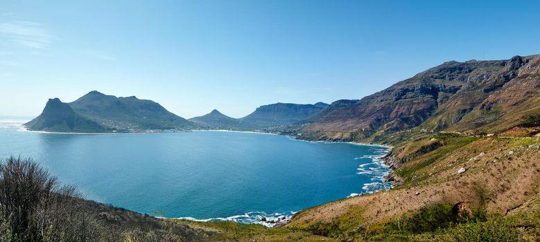 Wide angle panorama of mountain coastline against clear blue sky in South Africa. Scenic landscape of Twelve Apostles mountain range near a calm ocean in Hout Bay. Popular hiking location from above