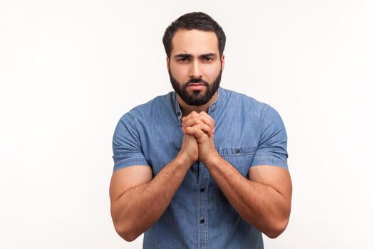 Emotional young bearded man on gray background.