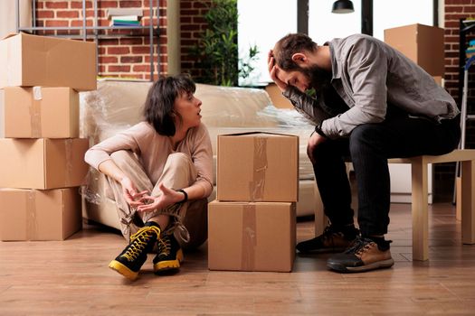 Frustrated married couple fighting in new apartment flat
