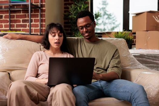 Diverse couple looking at decor inspiration on internet website