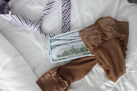 Women stockings men tie and cash dollar bills