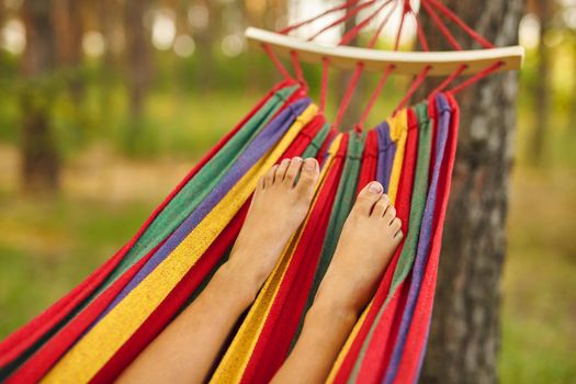 Foot of a child lying in the hammock and relaxing