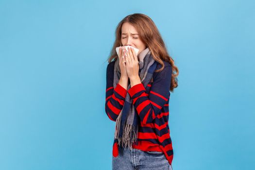 Woman wrapped in warm scarf, coughing, feeling unwell suffering fever, seasonal influenza symptoms.