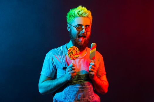 Hipster emotional man on colorful neon light background.