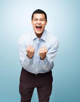 Express your excitement about life. Shot of a young man shouting in joy against a studio background.
