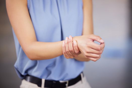Ouch. Cropped shot of an unrecognizable contractor experiencing pain in her wrist.