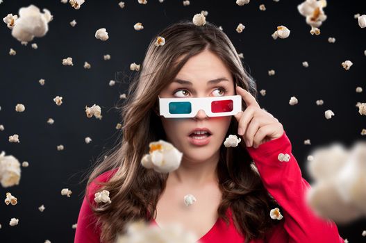 Its raining kernels. Shot of a young woman wearing 3D glasses against a studio background.