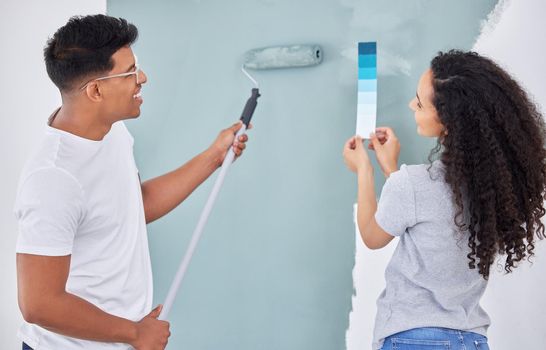 We just love a DIY project. Shot of a young couple looking at a color swatch while busy renovating a house.