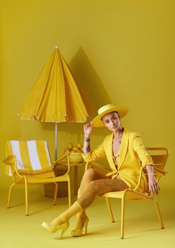 My soul is yellow. Studio portrait of a young woman dressed in stylish yellow clothes against a yellow background.