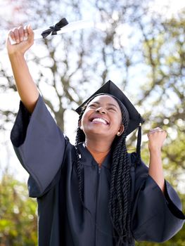Sparkling with promise of a bright future. Shot of a young woman cheering on graduation day.