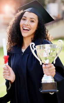 She truly deserves the title of Top Achiever. Portrait of a young woman holding a trophy and cheering on graduation day.
