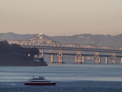 Ferry Boat races by Oakland Bay Bridges