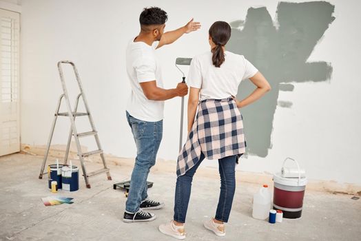 Were having second thoughts about this colour. Shot of a young couple painting a room together.