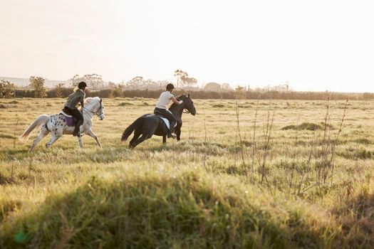 You go at your own pace. Shot of two young women out horseback riding together.