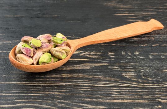 Pistachio nuts without shell in spoon