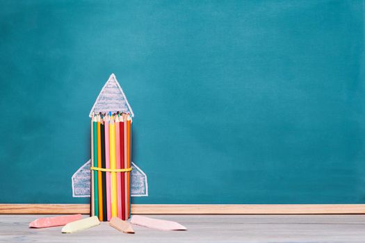 rocket made with crayons on a blackboard