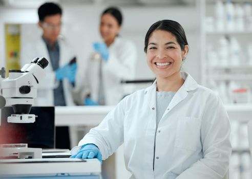 Shes the expert in her field. Shot of a confident young female scientist in her lab.
